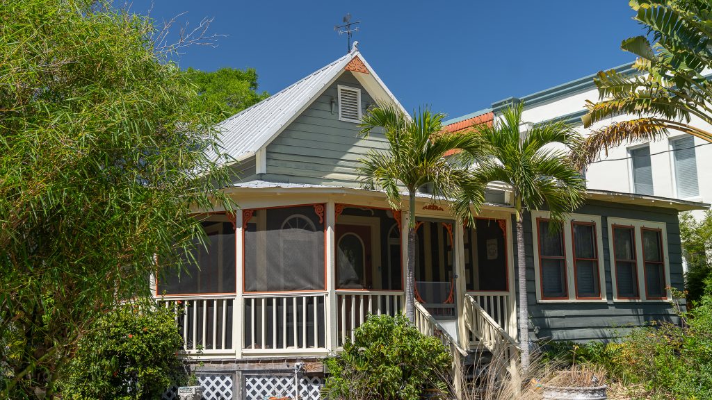 Historic bungalow in Laurel Park Sarasota with shaded oak trees and classic front porch
